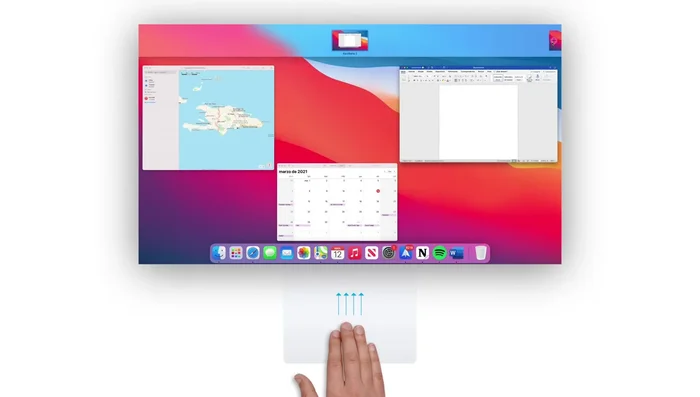 Administrar escritorios: Deslizar hacia arriba con tres dedos para ver todos los escritorios. Deslizar con tres dedos de lado a lado para cambiar entre ellos. Crear un nuevo escritorio desde la barra superior.